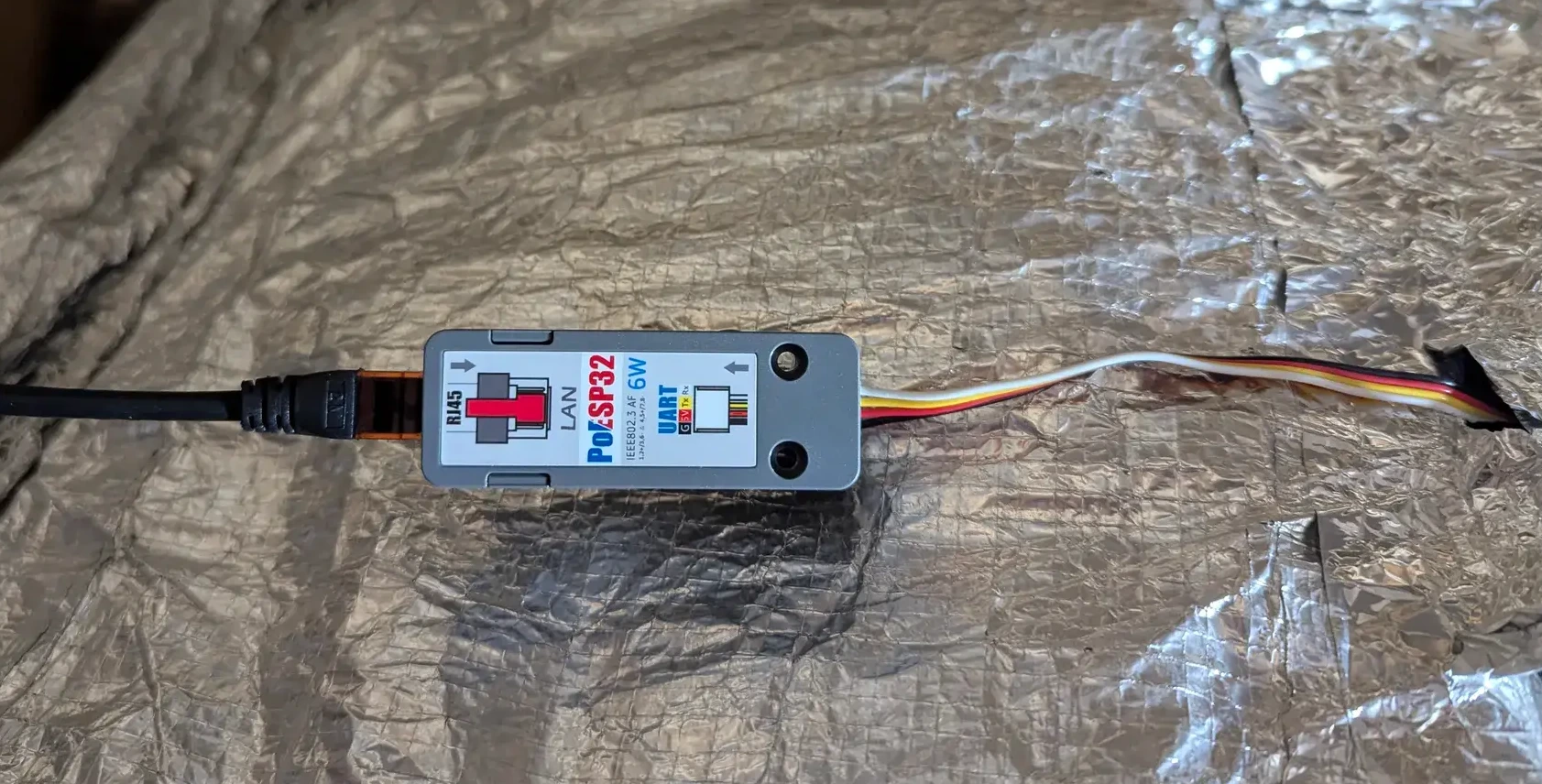 The PoE ESP32 sitting on top of the tank
